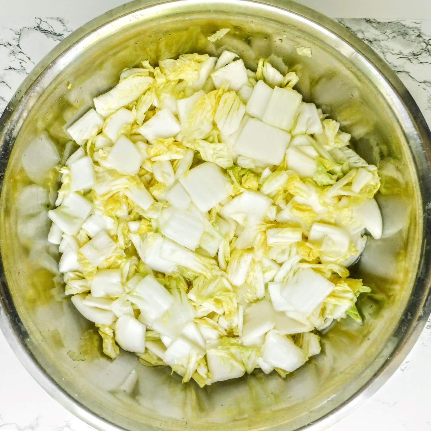 Large bowl containing cut napa cabbage