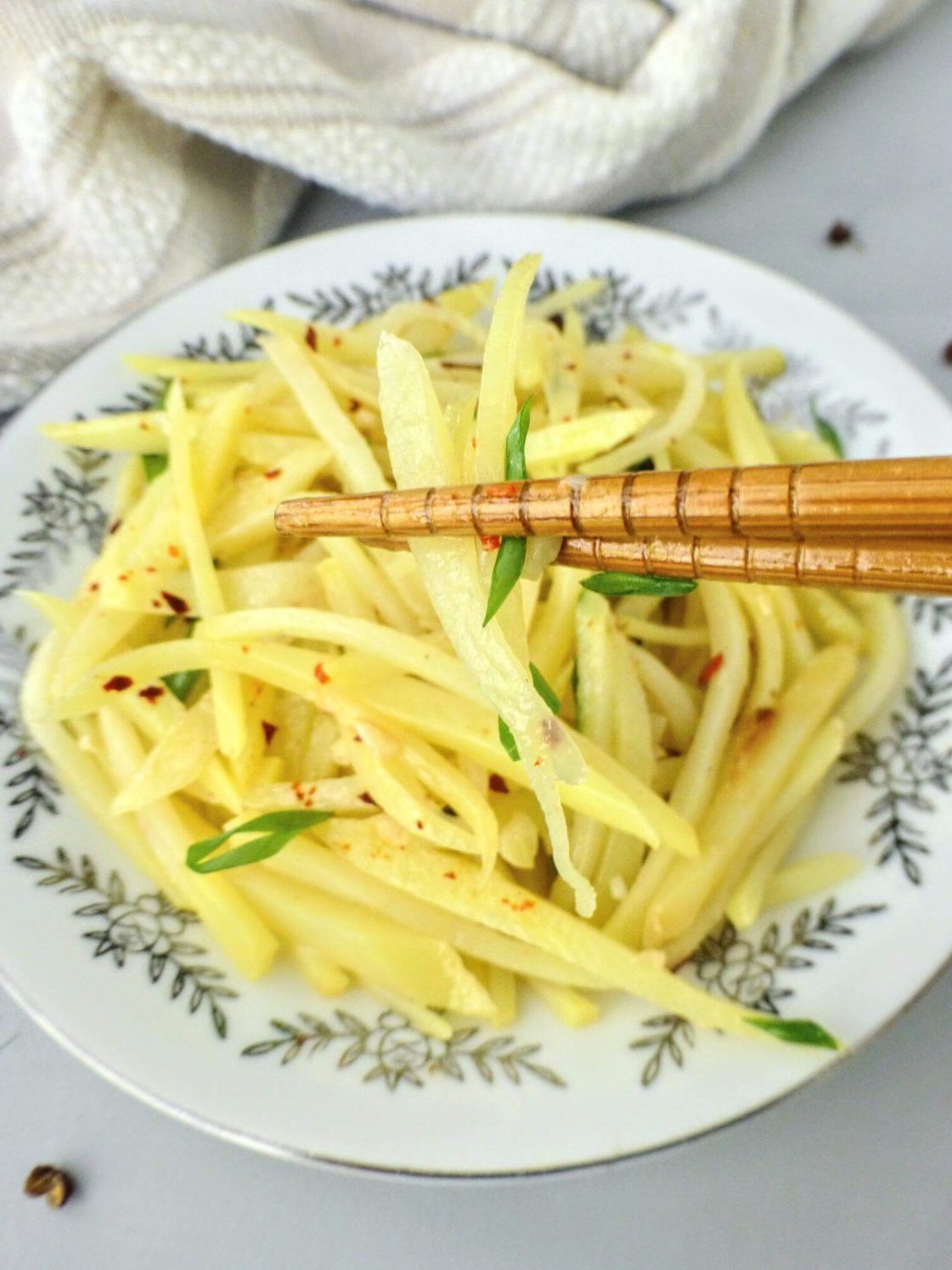 Sichuan Potato Stir-fry (Suan La Tu Dou Si) with chopsticks