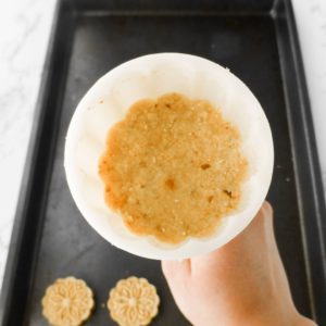 Packing the mooncake mold with Macau almond cookies mixture